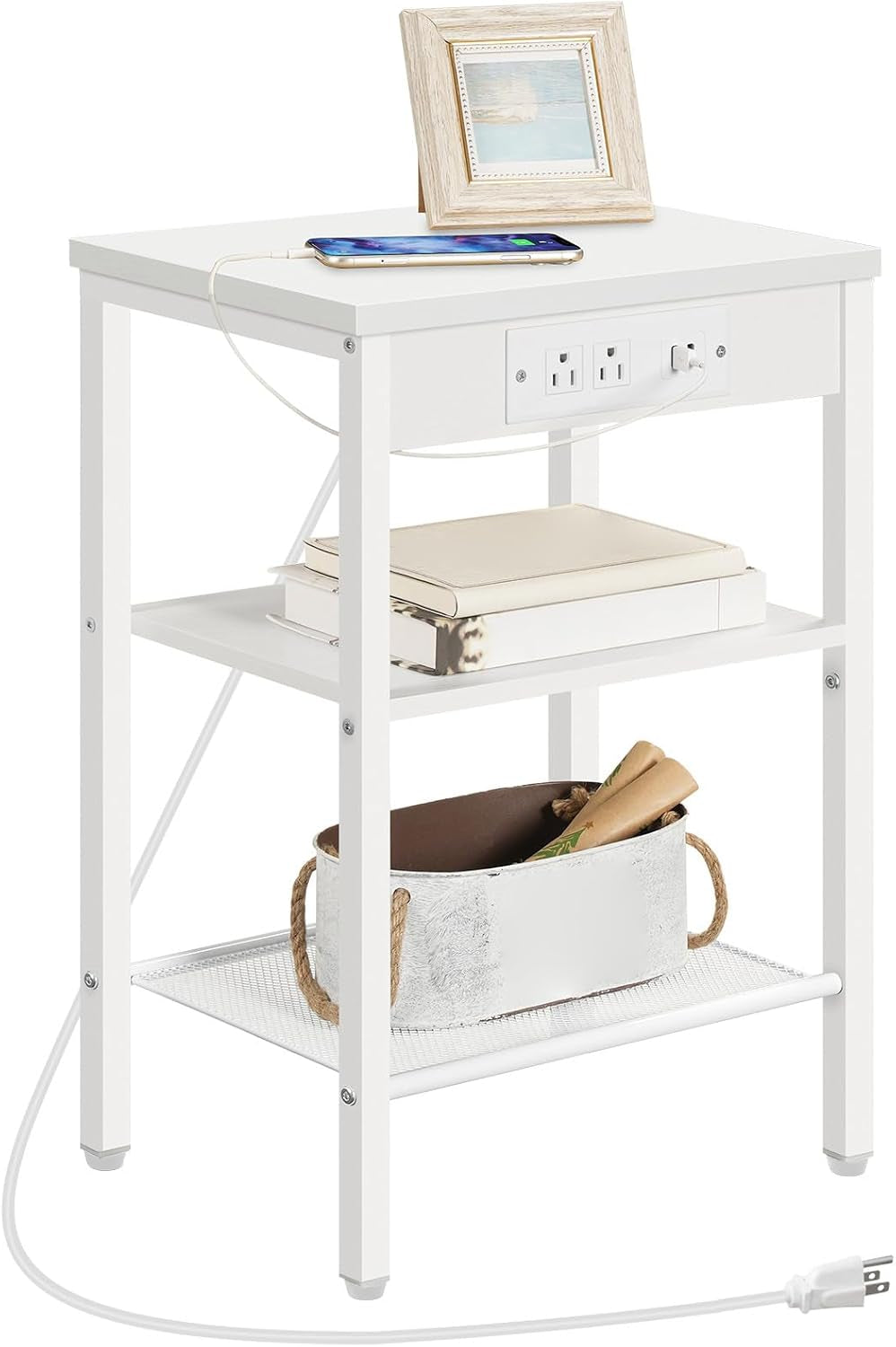 White side table staged with phone charging on top, books on middle shelf and basket on mesh bottom shelf