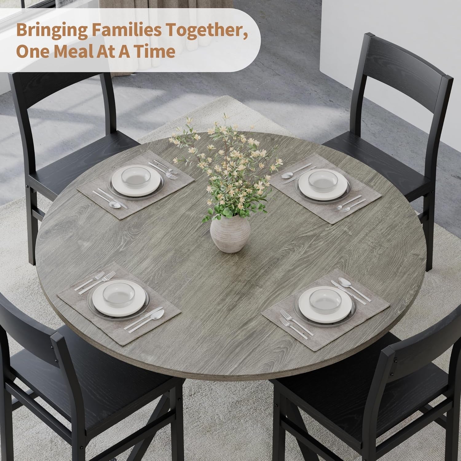 Top-down view of the round tabletop arranged for four place settings