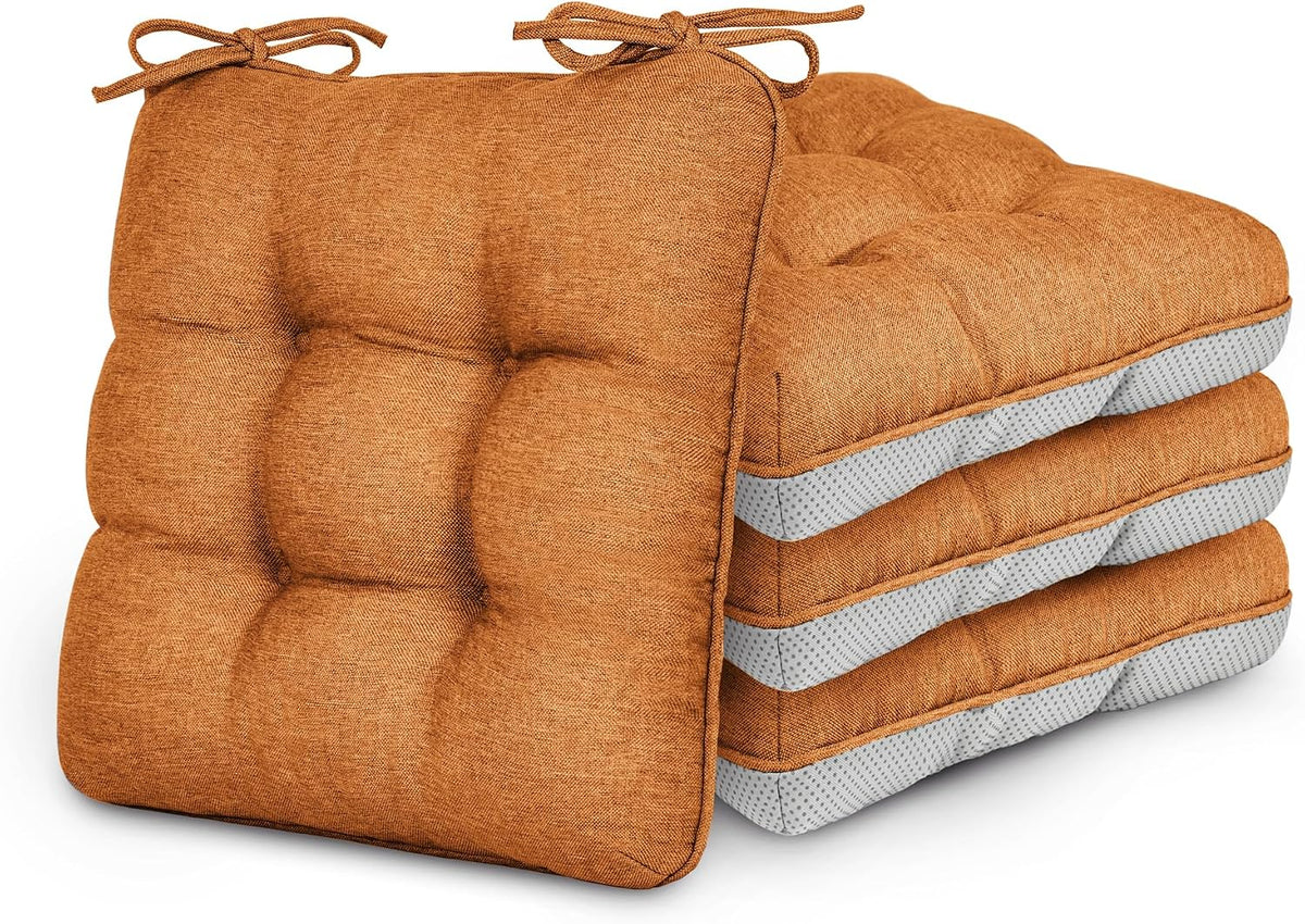 Set of four tufted square chair cushions in orange with gray mesh side panels and ties