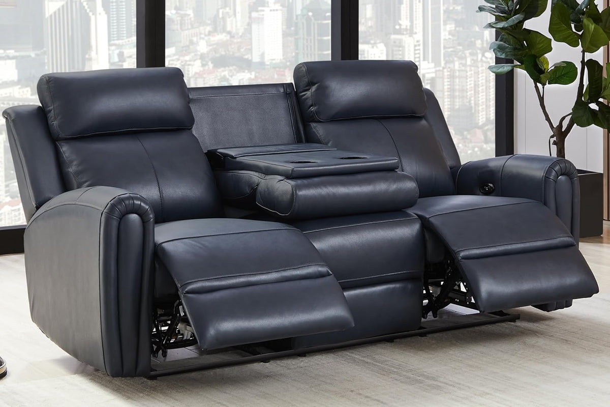 Navy blue leather reclining sofa with center console down and both footrests extended against a city-view window.