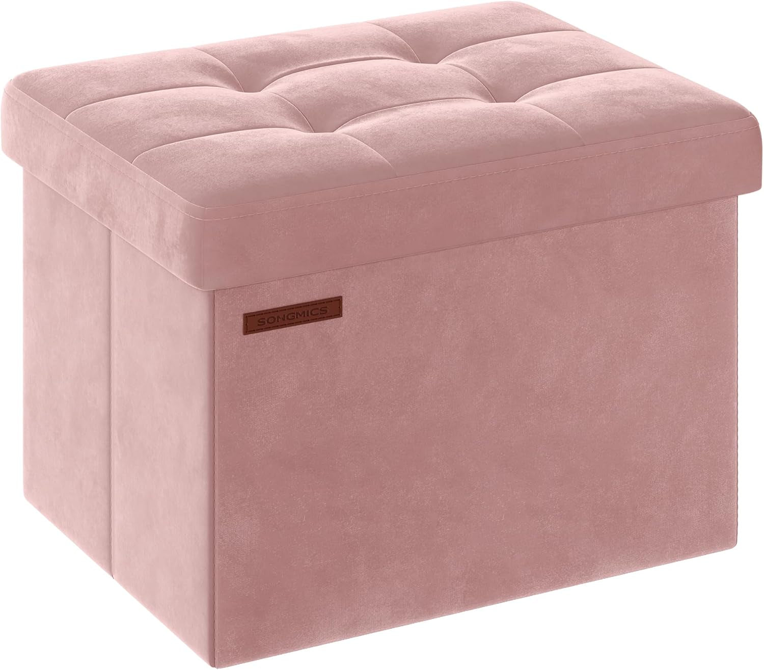 Three-quarter view of a blush pink tufted storage ottoman with a soft fabric finish and stitched top.