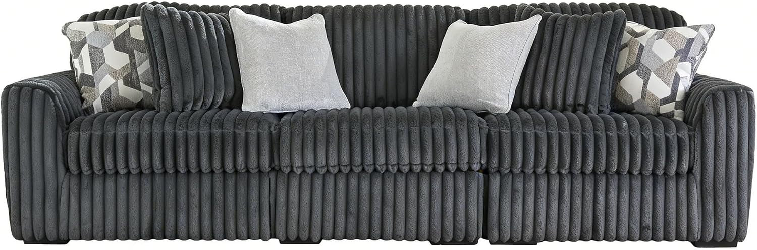 Front view of a charcoal-gray ribbed oversized sofa dressed with several decorative pillows.