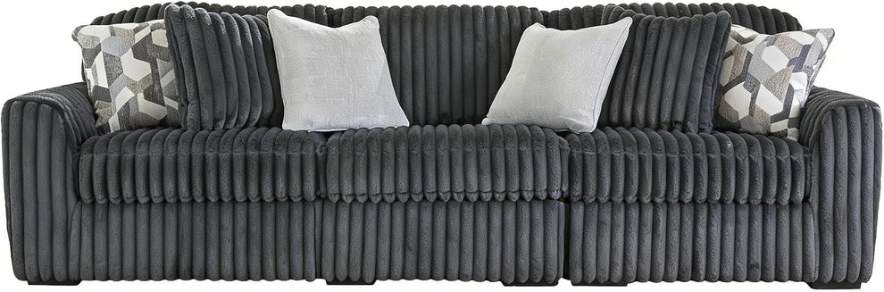 Front view of a charcoal-gray ribbed oversized sofa dressed with several decorative pillows.