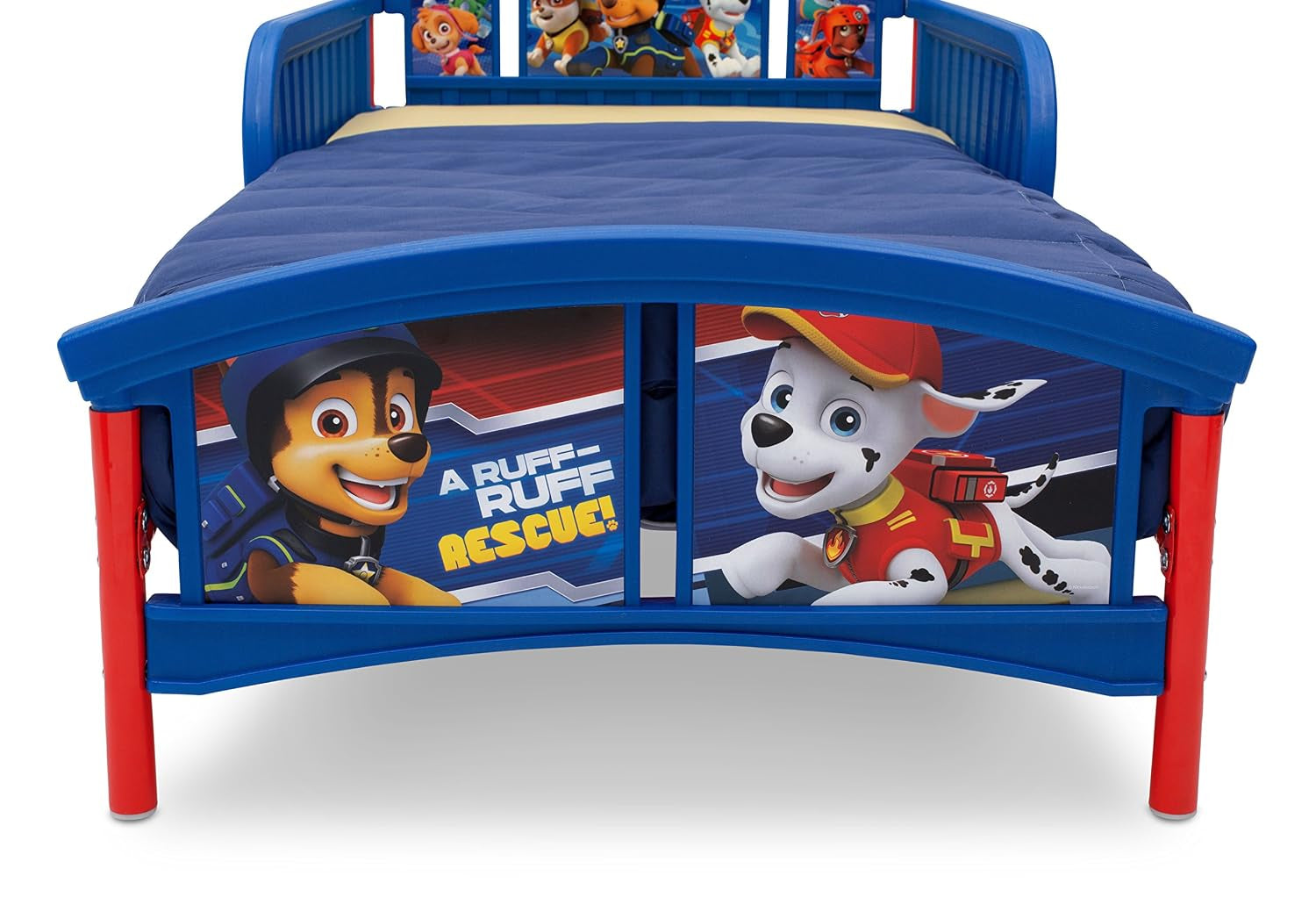 Front view of the toddler bed footboard showing large Paw Patrol character panels, red legs and navy bedding.