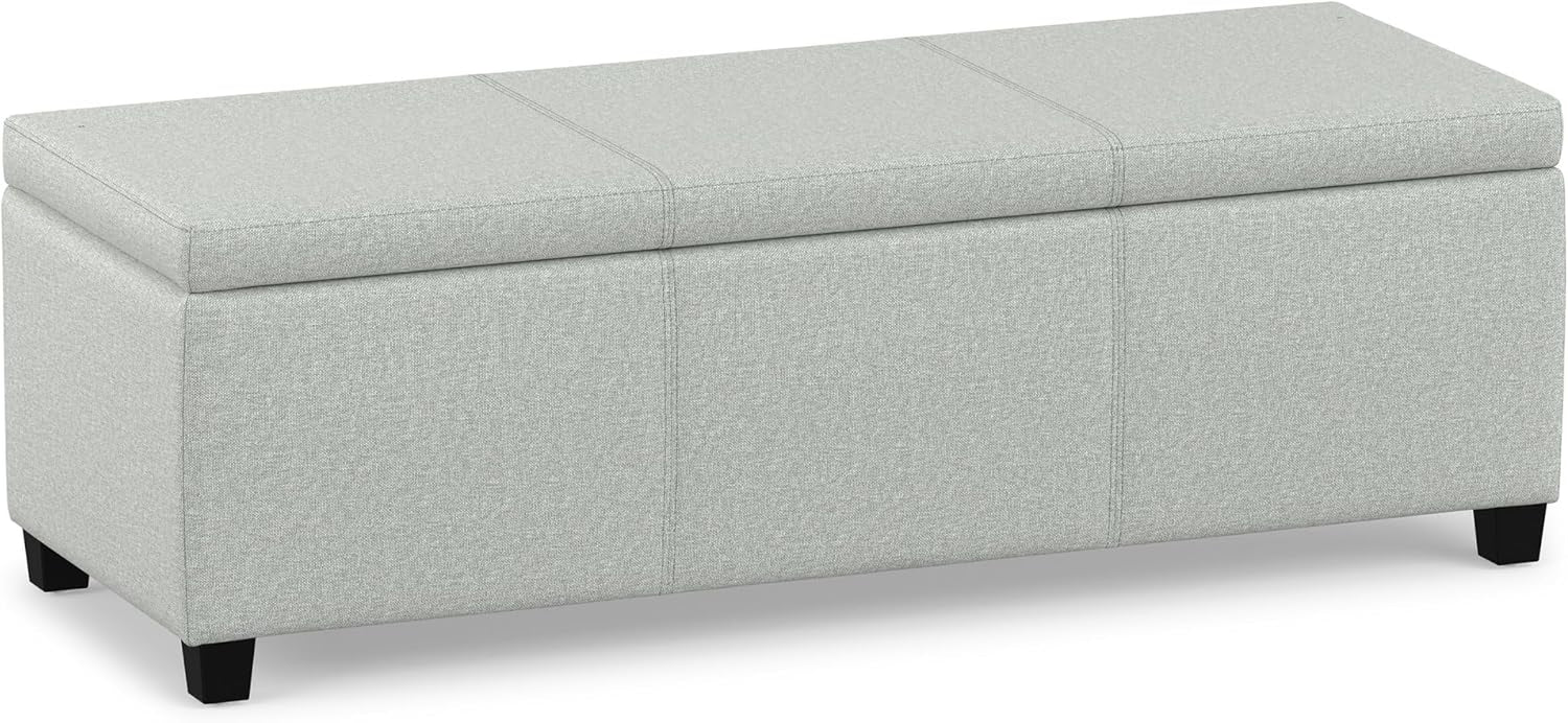 Light gray fabric rectangular storage ottoman with seam details across the padded lid and black legs.