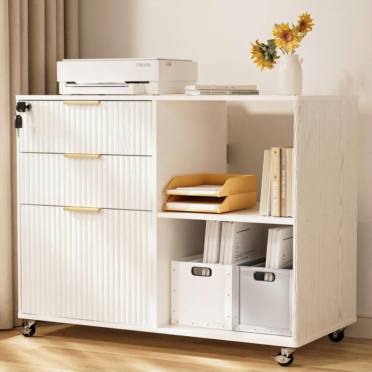 Front-facing detail of a white wood cabinet with vertical fluted drawer fronts, open shelving and a yellow paper tray.