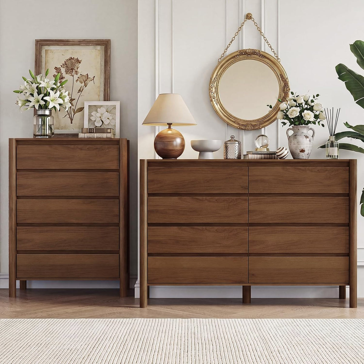 Front view of two matching walnut dressers side by side with a lamp, mirror and floral decor.