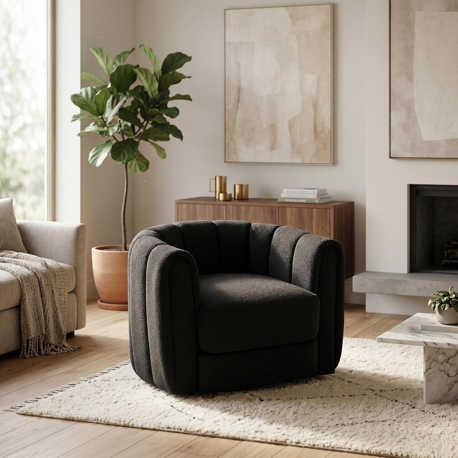 Dark-colored barrel swivel chair placed on a rug in a modern living room vignette.