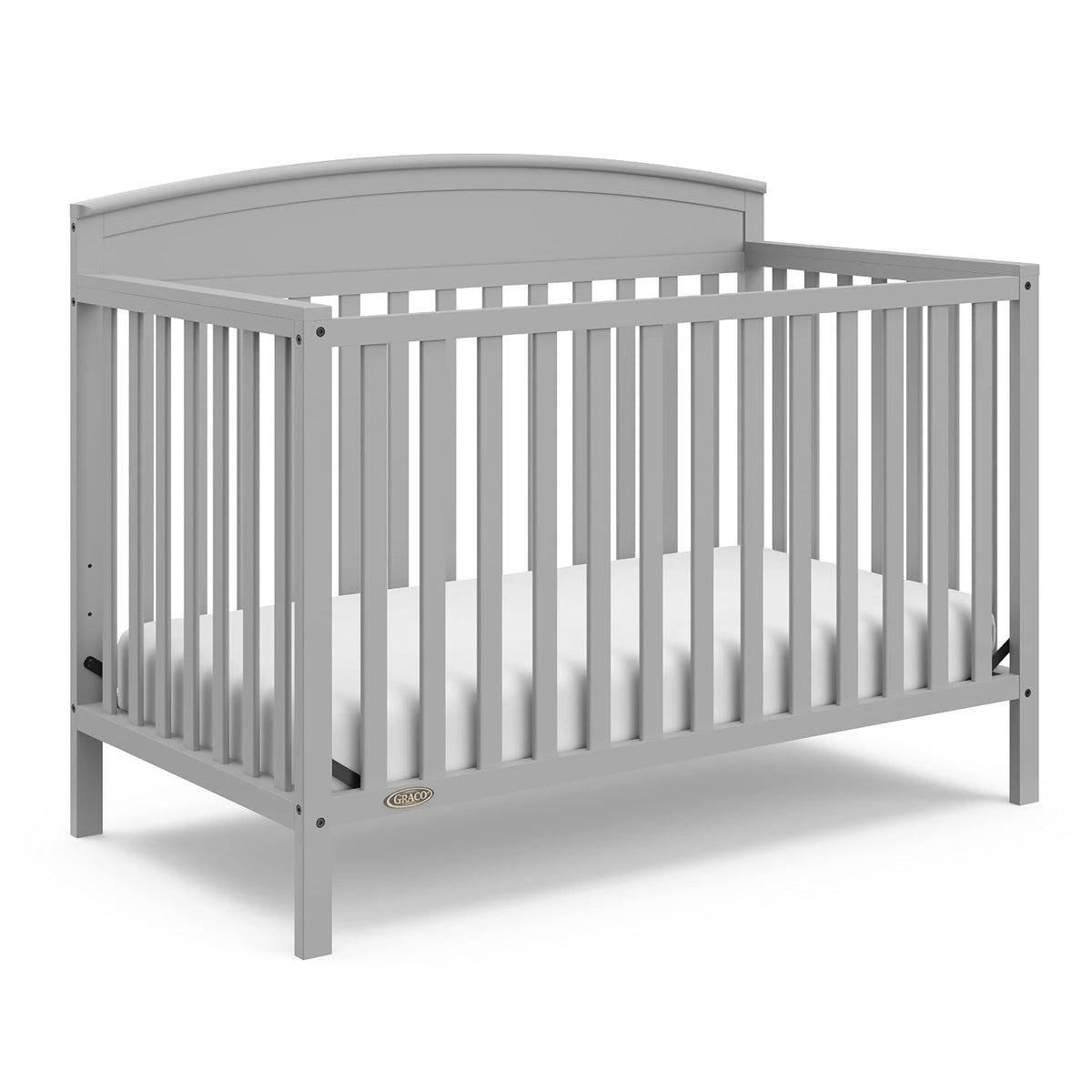 Gray convertible crib without changing table shown from the side with mattress inside