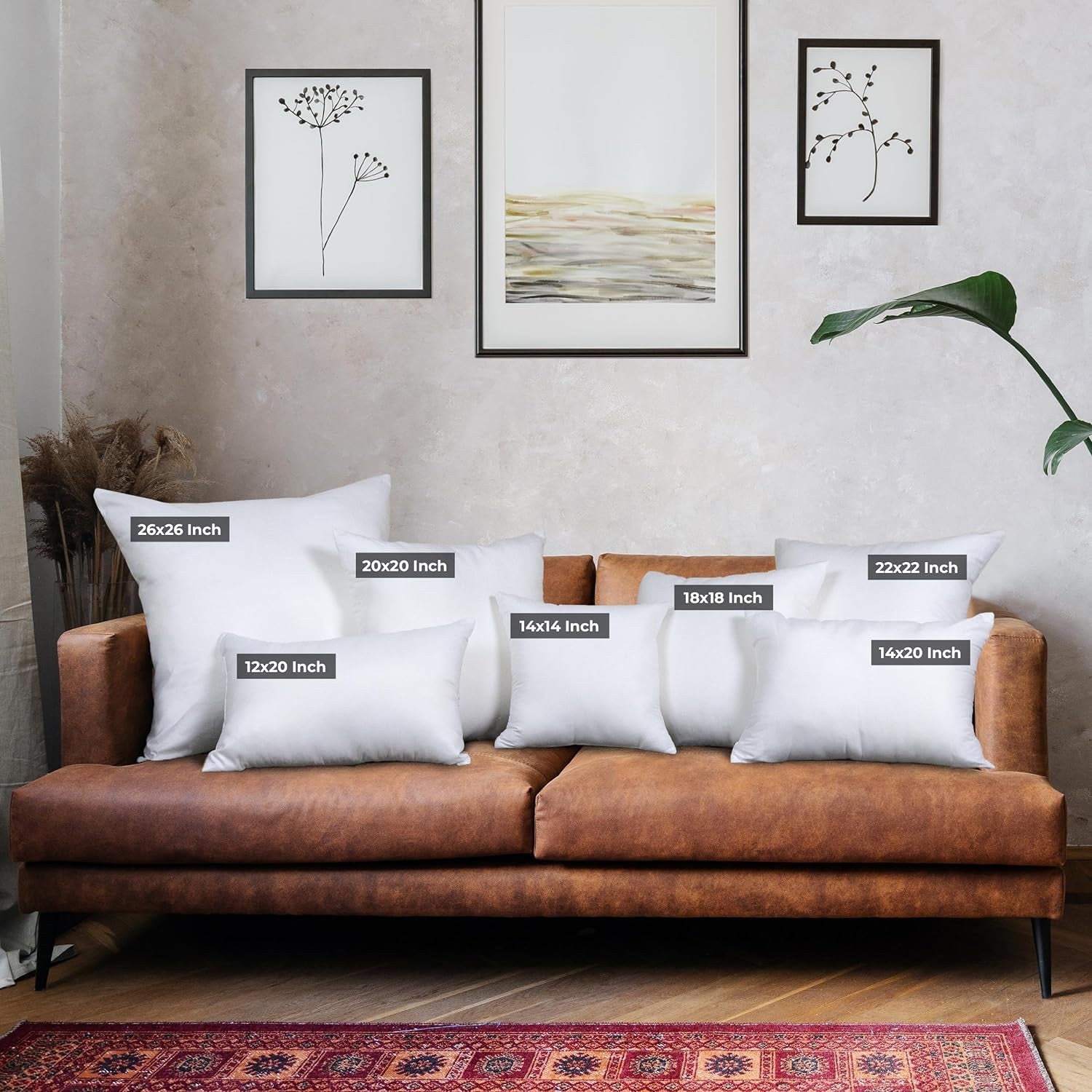 Living room sofa styled with assorted white pillow inserts showing labeled size tags across the seating