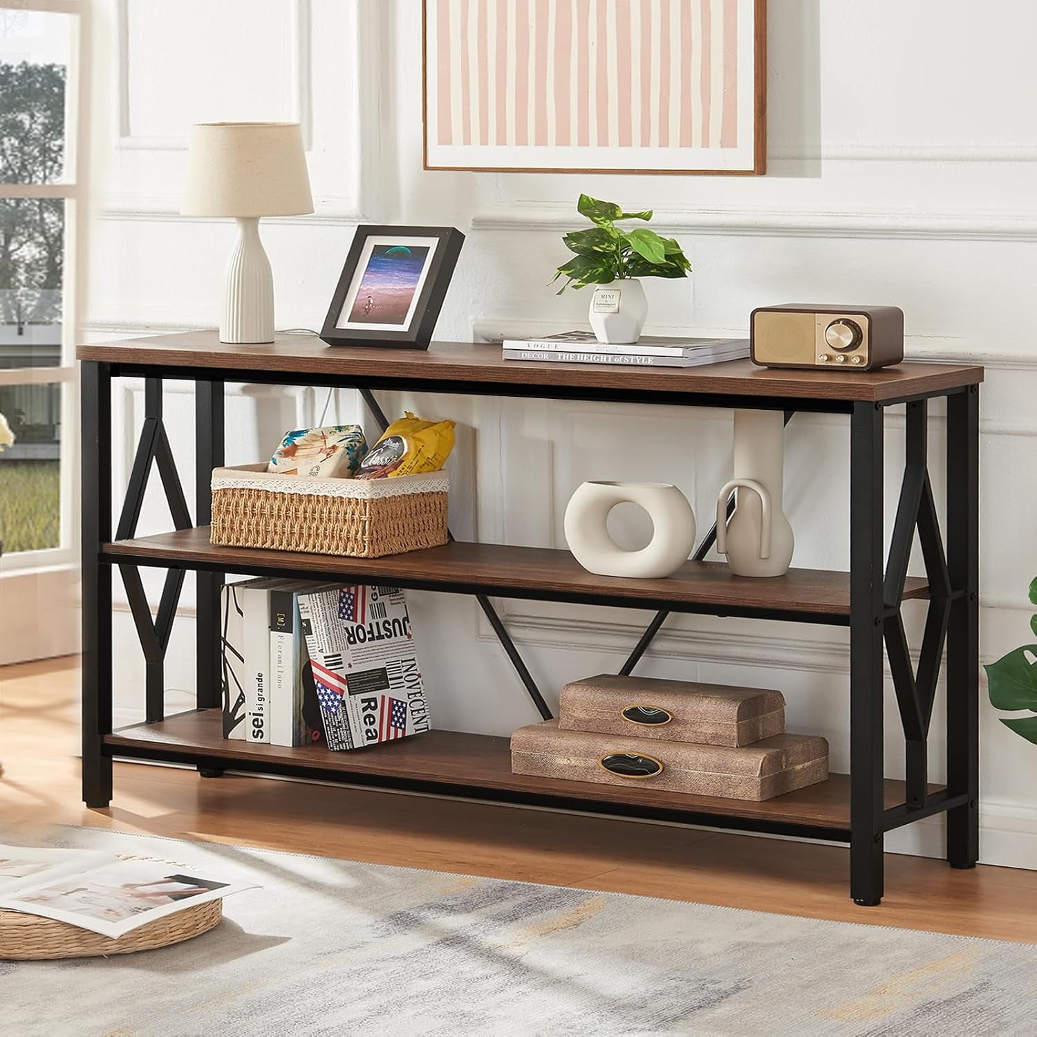Angled view of the rustic brown console with black metal X‑side supports and tabletop decor.