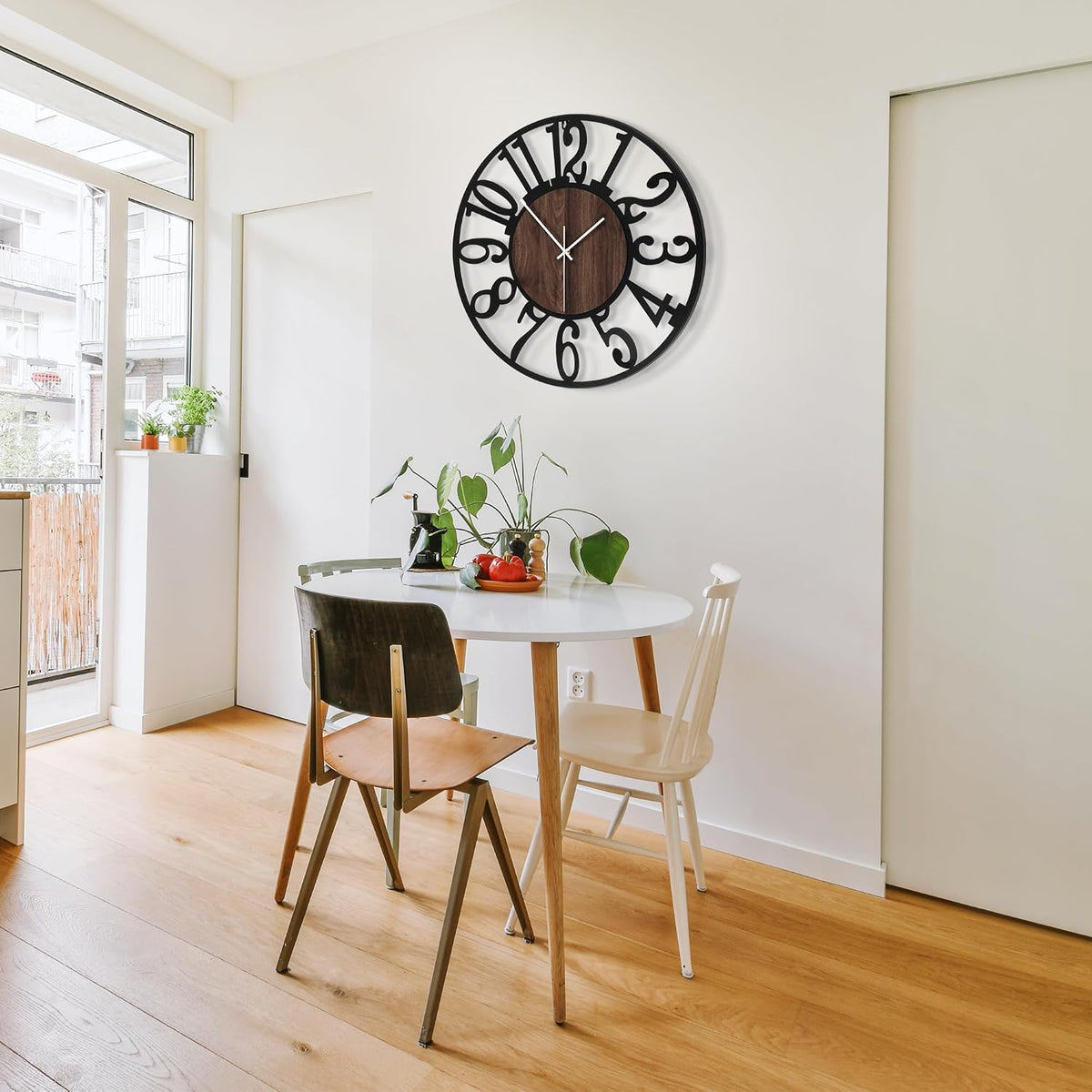 Wide dining nook shot showing the black metal clock with wood center above a round table