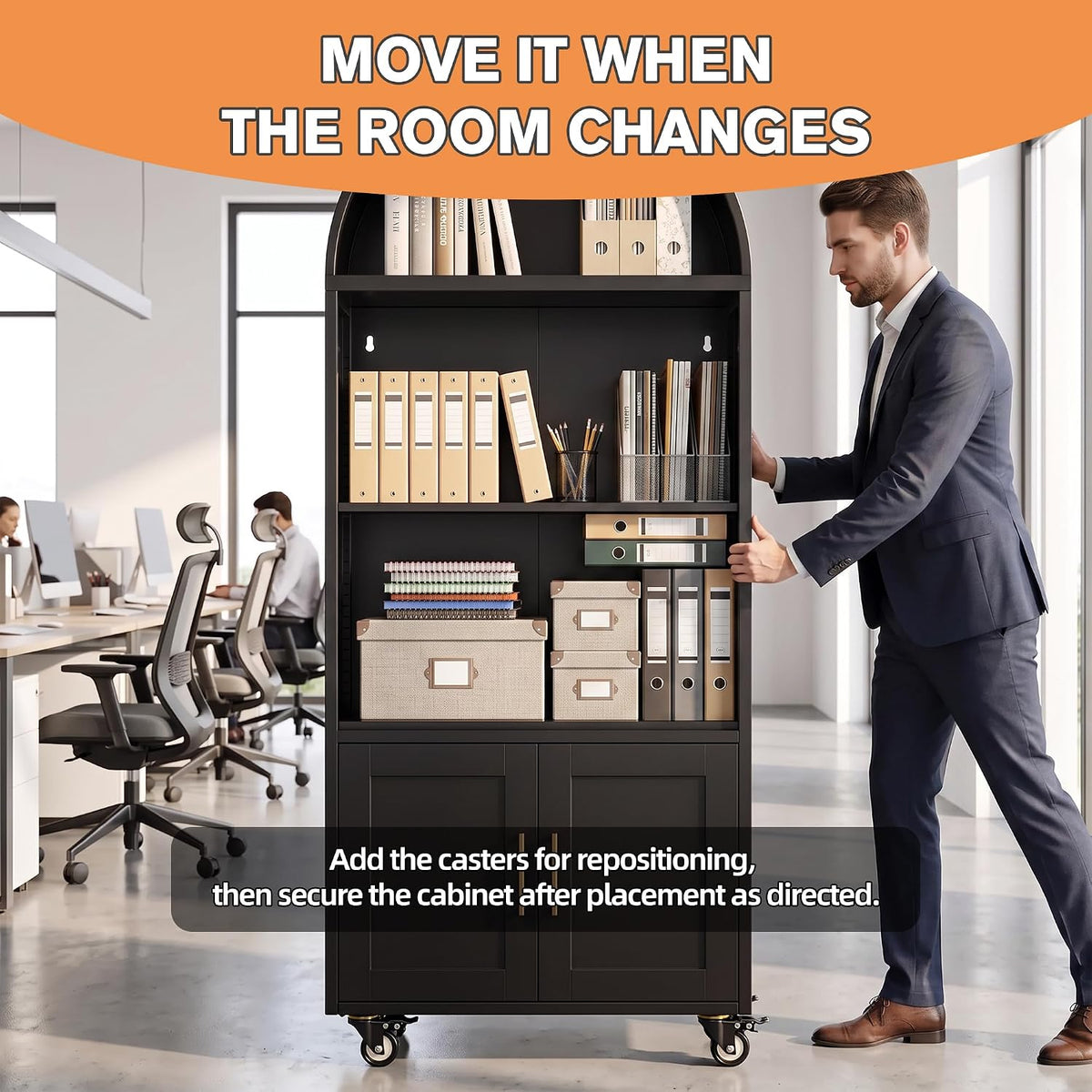 Man in suit pushing a black arched bookshelf on casters in a bright office with desks and chairs behind it