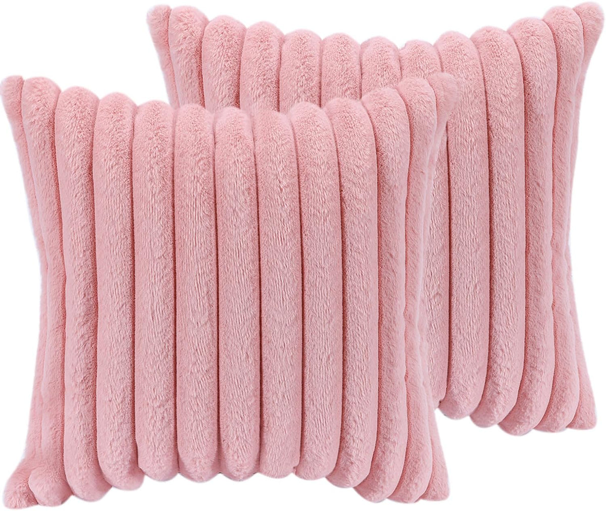 Two overlapping pink faux-fur ribbed throw pillows filling the frame