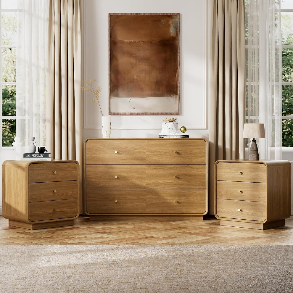 Oak-finish 3-piece bedroom set with 6-drawer dresser centered and two 3-drawer nightstands flanking it in a styled room
