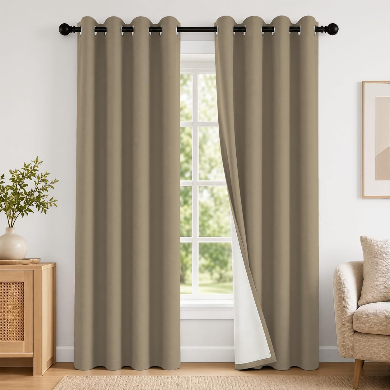 Full window with two taupe grommet curtains hung on a black rod, one panel slightly open showing white backing.