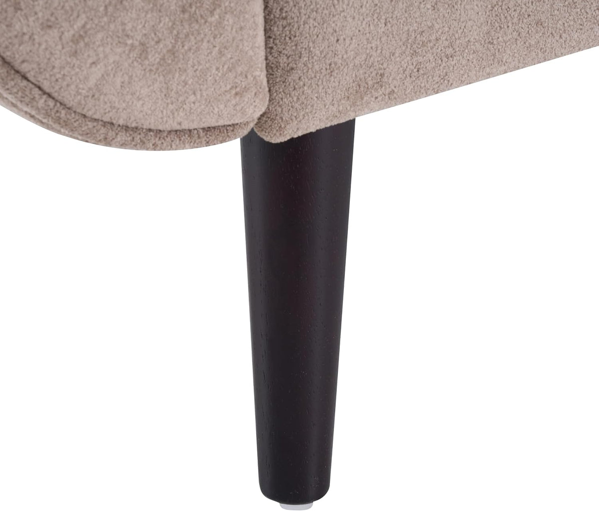 Close-up of a tapered dark wood leg under the light brown upholstered frame.