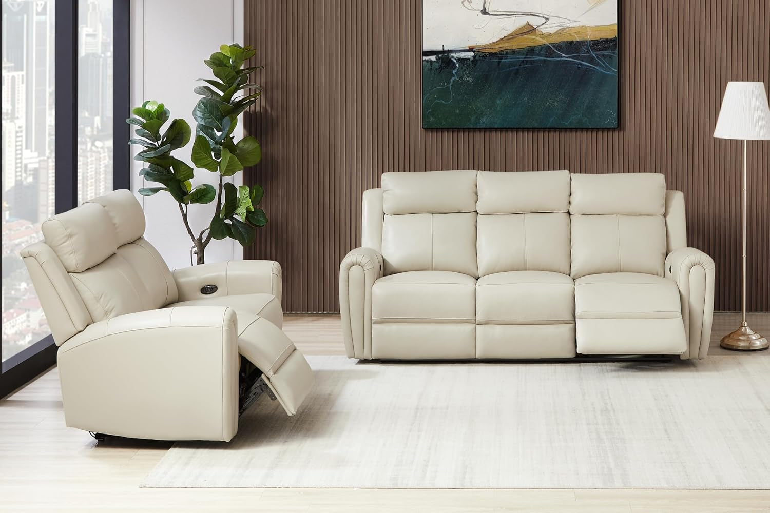 Front-facing view of beige leather three-seat sofa with matching two-seat recliner in a bright living room setting