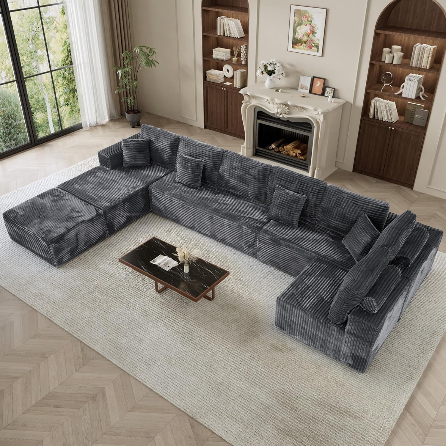 Top-down view of a large gray L-shaped modular sectional arranged around a low coffee table
