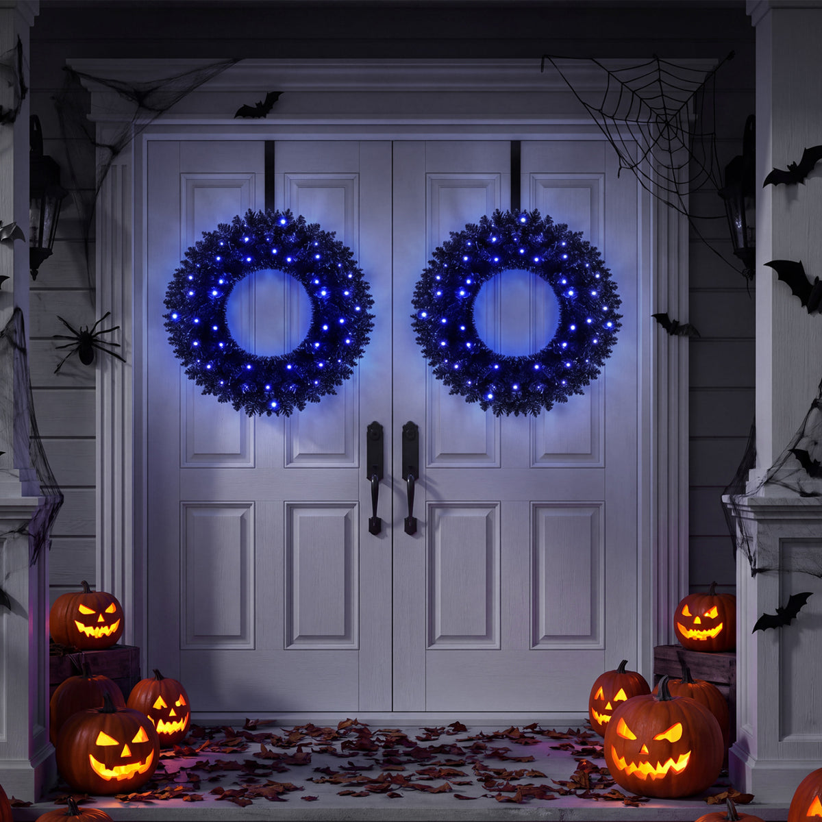 Two glowing wreaths hang on a decorated front door, surrounded by Halloween pumpkins and spiderwebs.