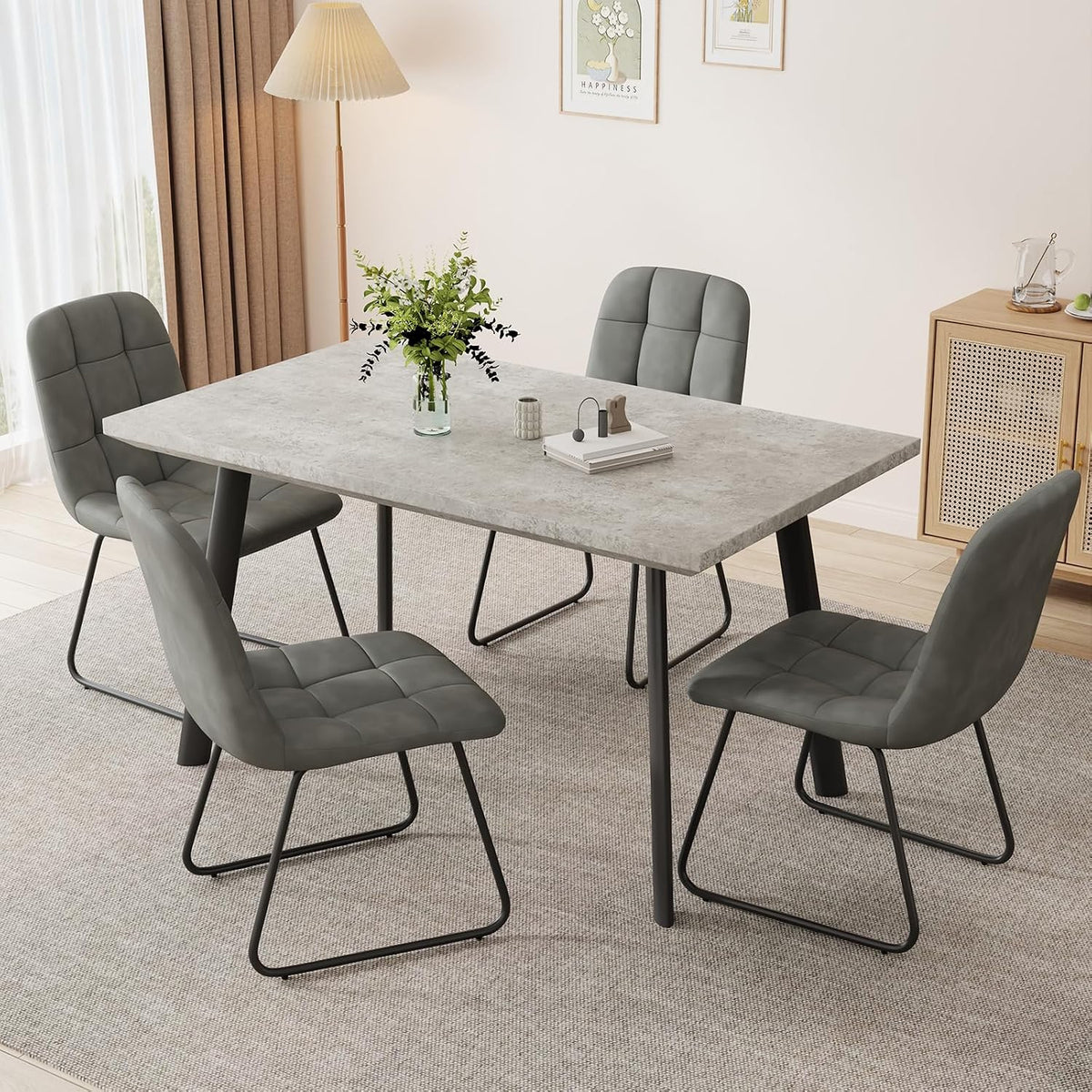Gray quilted PU chairs with sled-style black metal bases around a gray rectangular table in a light room.