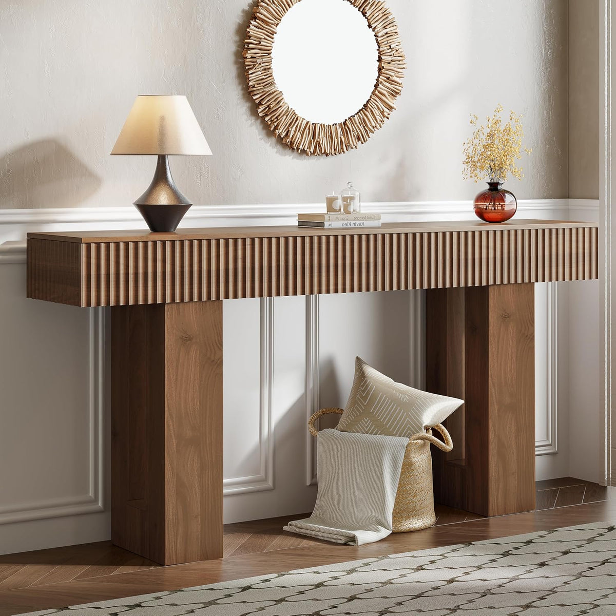 Warm natural wood fluted console table with matching legs, mirror above and cozy textiles stored below