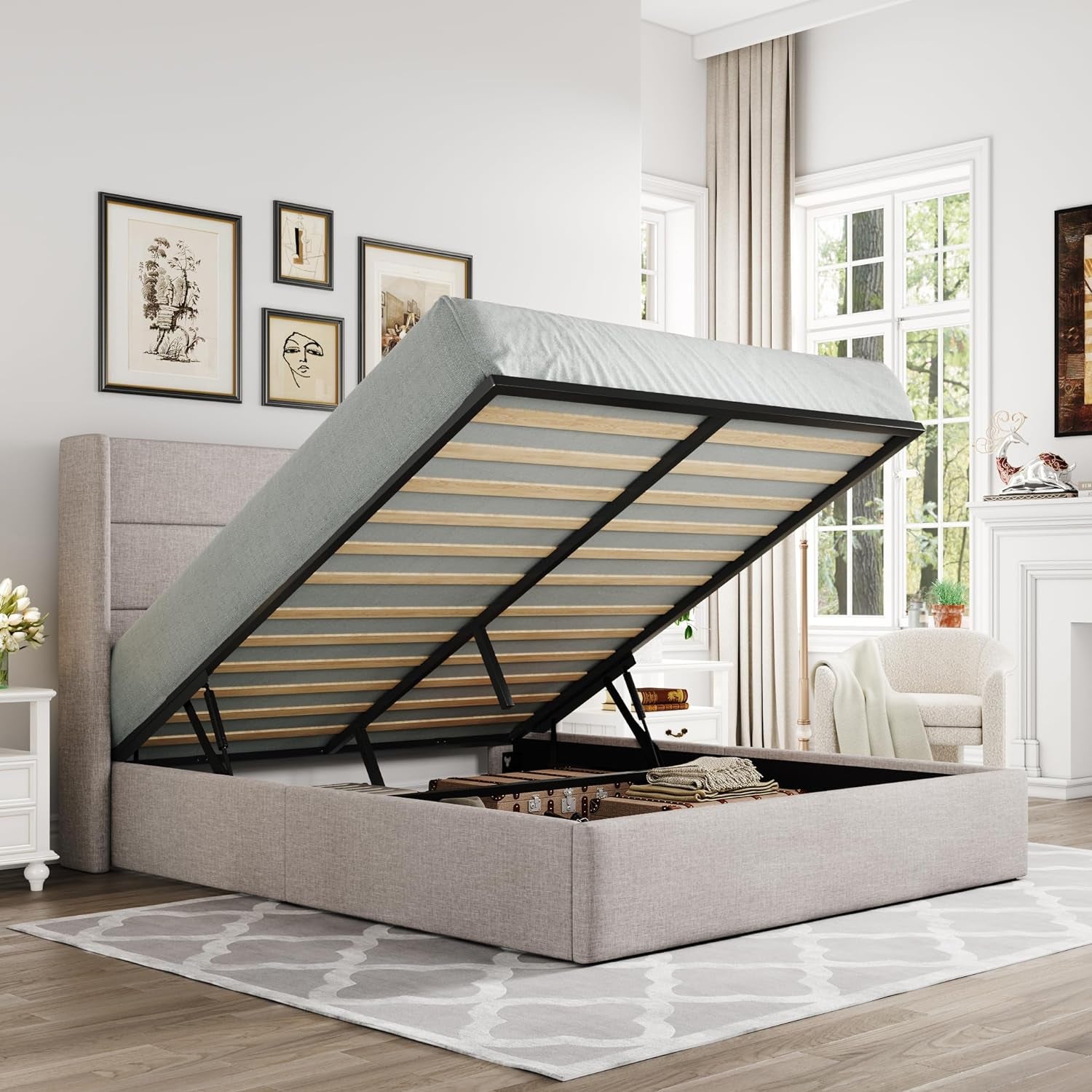 Light beige upholstered storage bed with lifted mattress exposing storage compartment