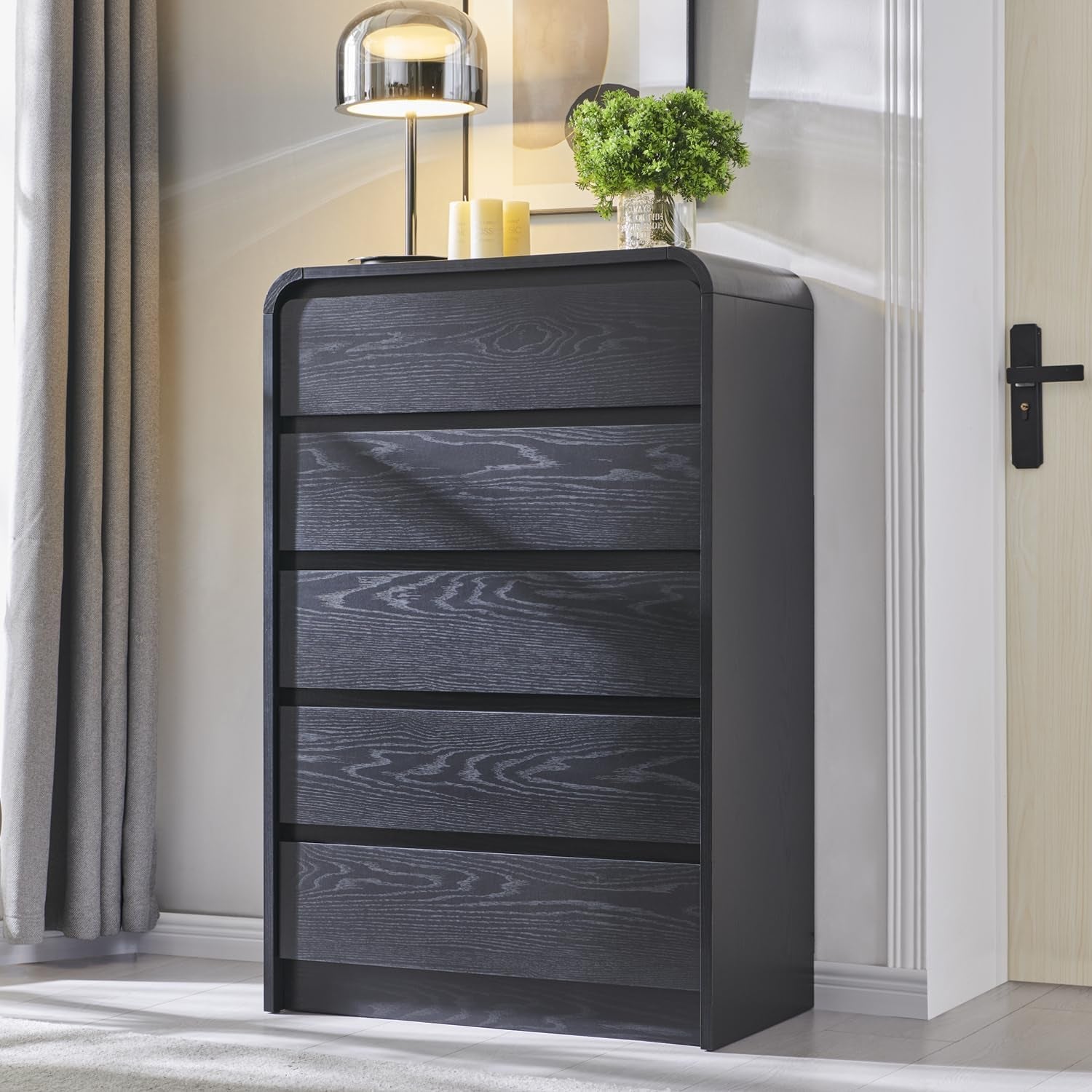 Tall dark charcoal chest seen from the left showing six shallow drawer fronts and subtle wood grain.