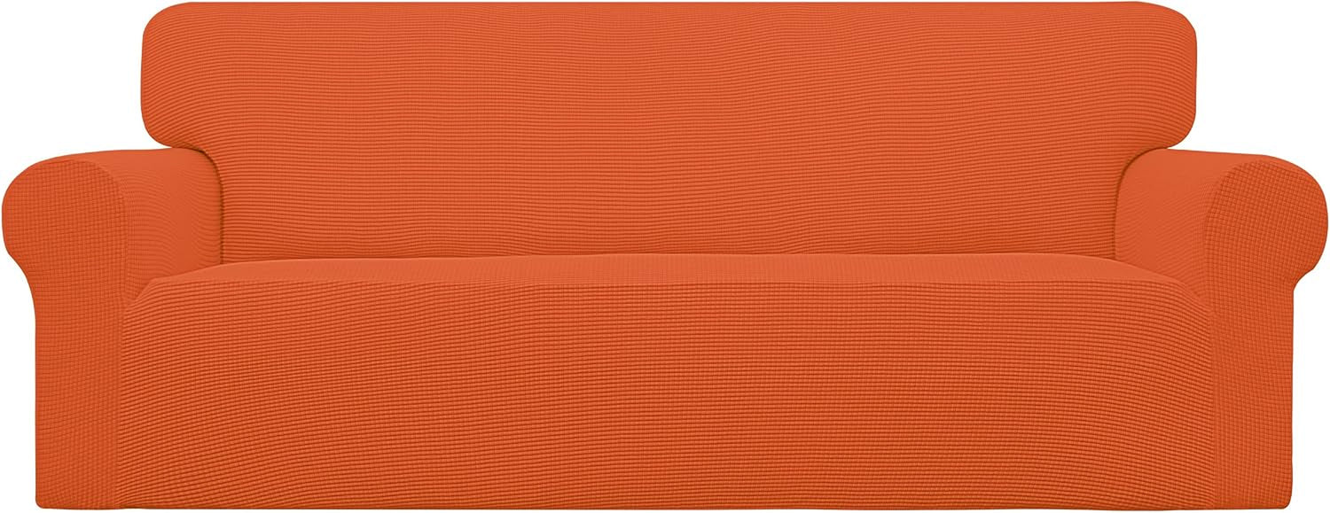 Bright studio front view of a two-cushion loveseat draped in a vivid orange textured cover.