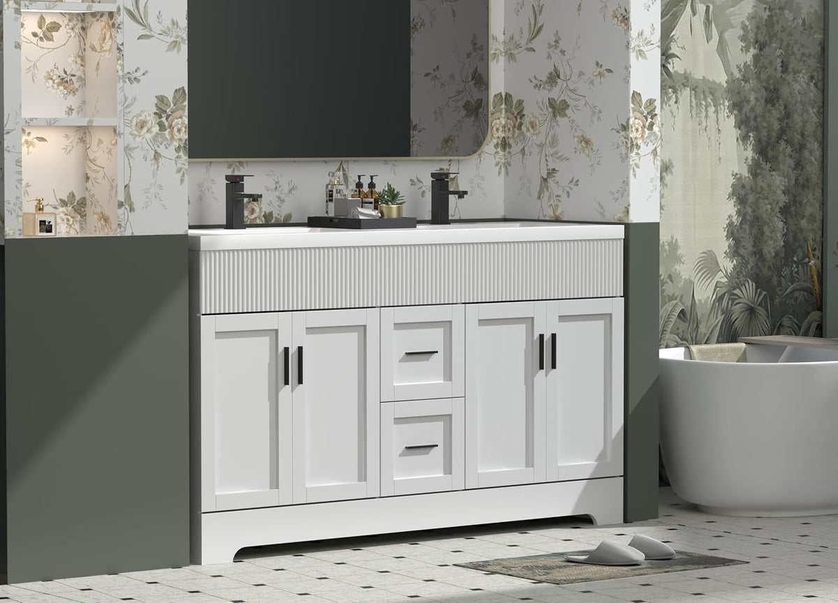Front view of the white bathroom vanity installed between green half-walls with floral wallpaper and a freestanding tub at