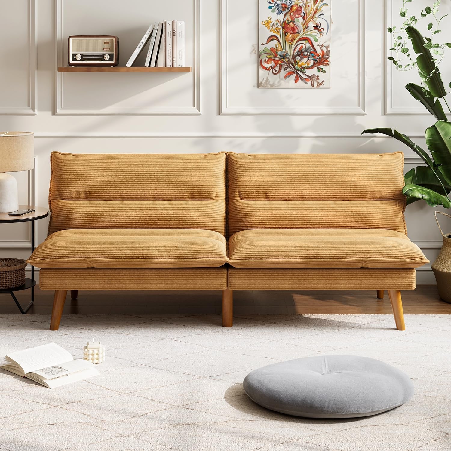Front-facing view of a two-seat mustard corduroy futon loveseat against a white paneled wall