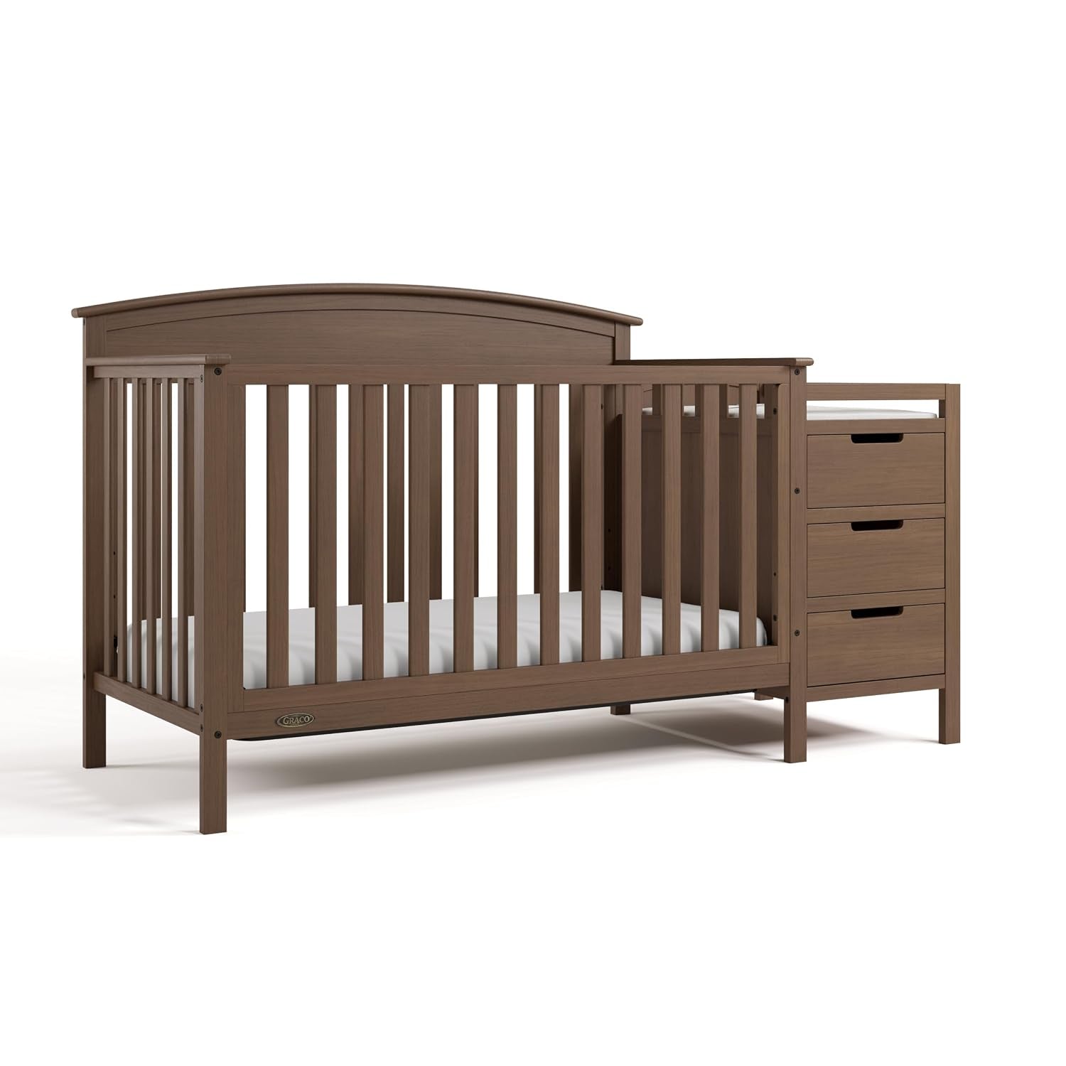 Warm brown convertible crib with attached three-drawer changing table angled to show headboard