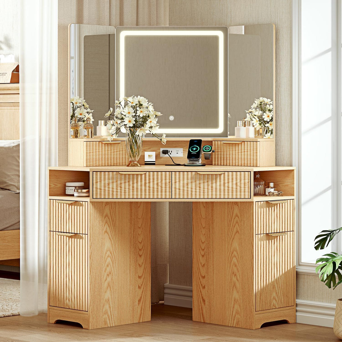 Light wood vanity with fluted drawer fronts, three-panel mirror with lit square center and open side shelves