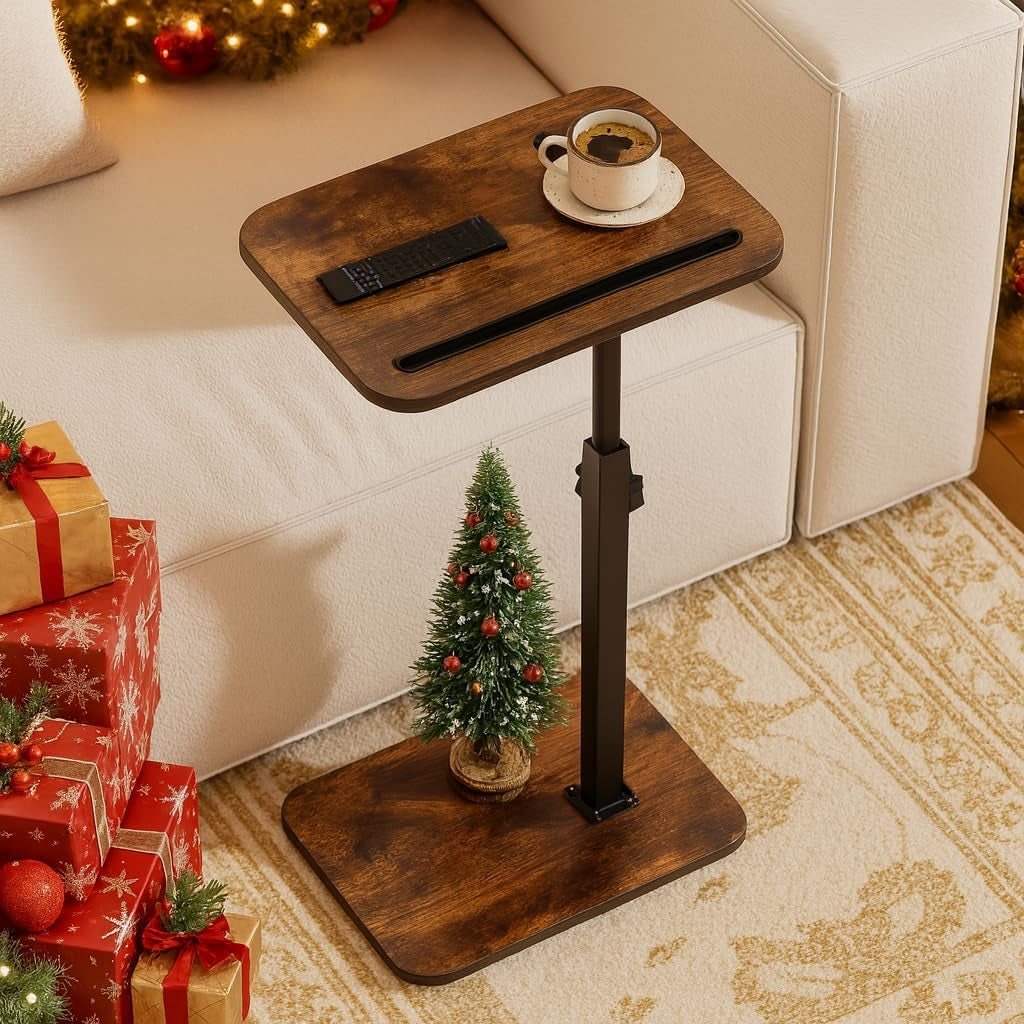 Dark wood C-table beside a white sofa with a coffee cup and remote on top and small Christmas tree at the base.