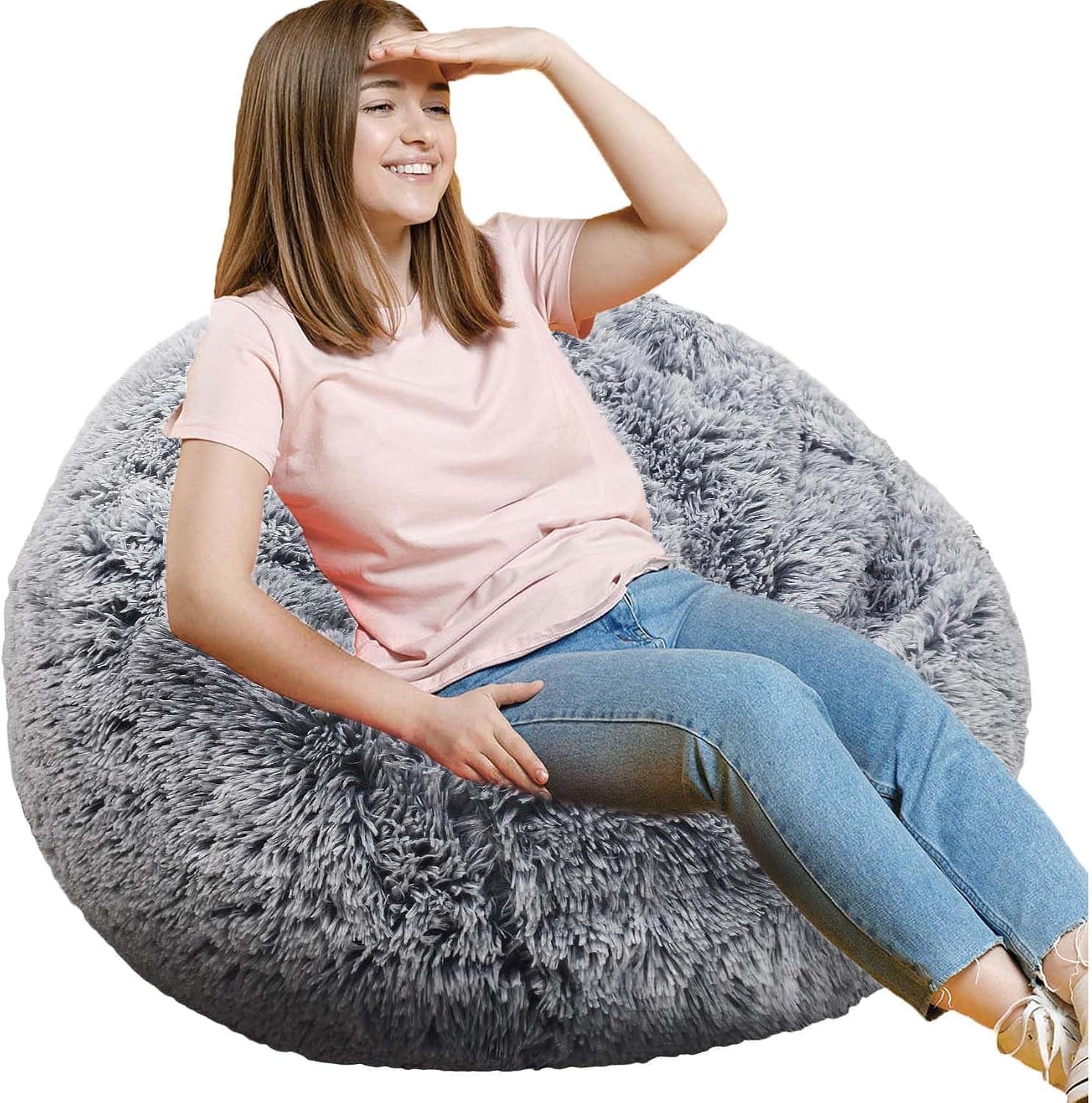 Smiling girl reclining on a shaggy light gray round bean bag chair.