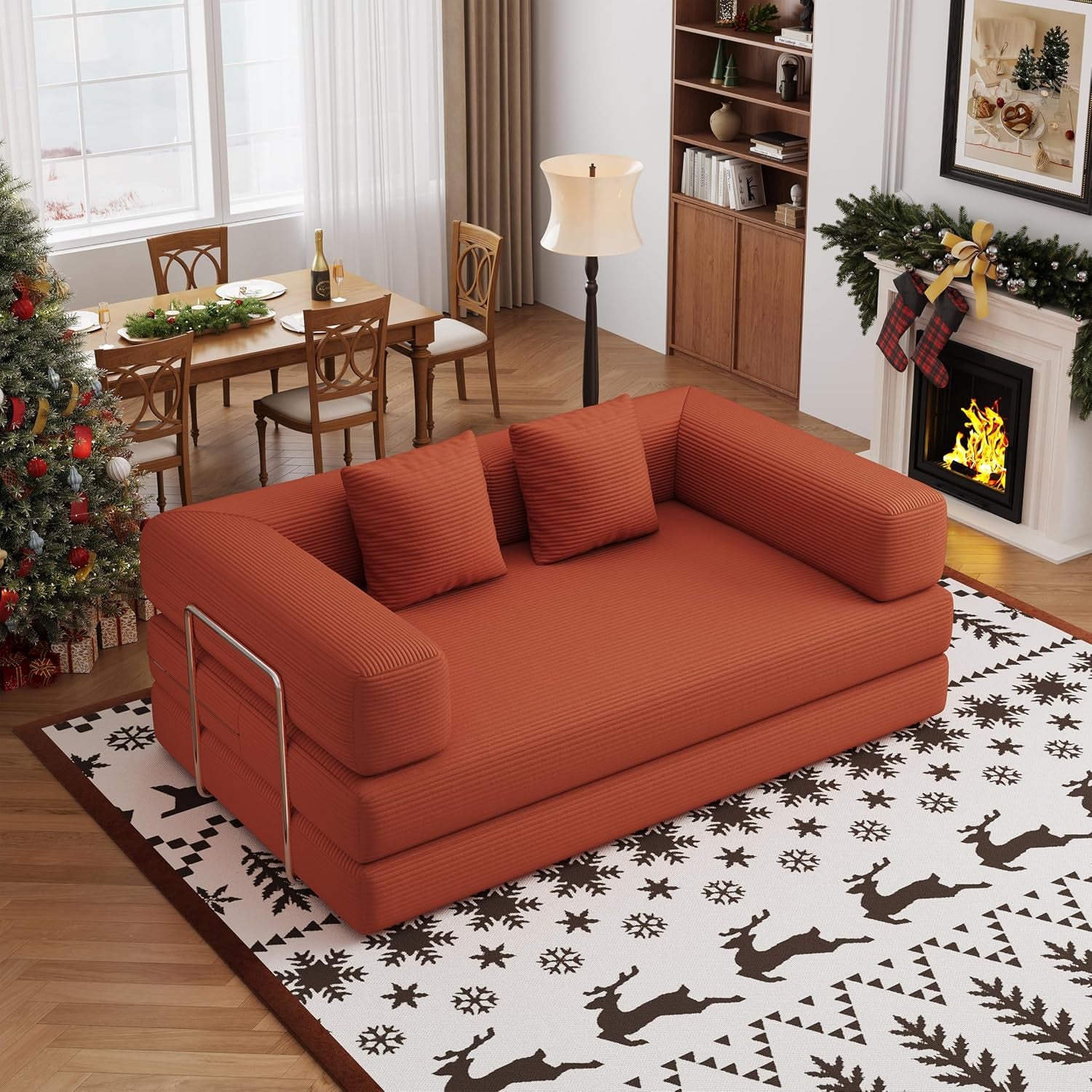 Angled view of a rust corduroy convertible sofa bed in a decorated living room with fireplace