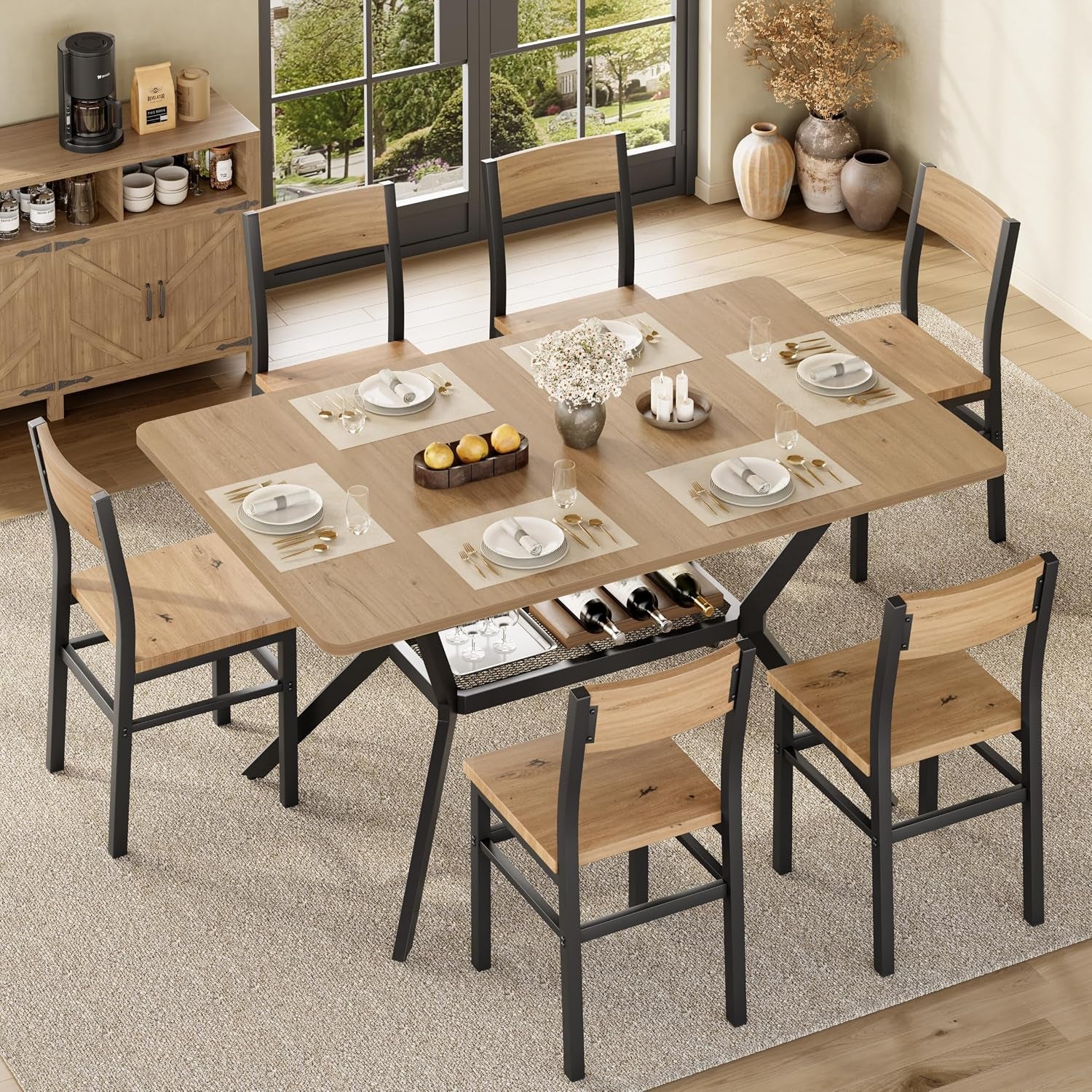 Overhead angled view of a light-walnut dining set with place settings and the under-table mesh shelf holding bottles.