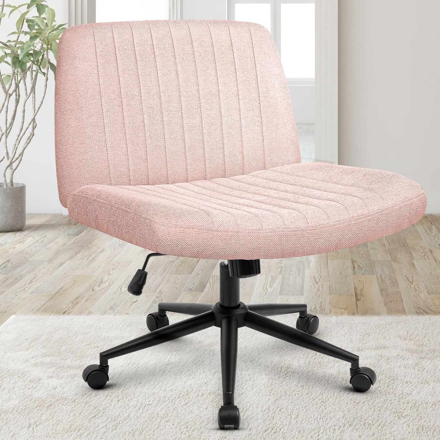 Front three-quarter view of a pale pink textured swivel chair showing cushioned seat, stitched channels, and black caster