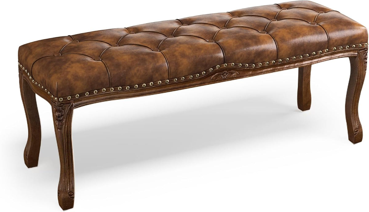 Cropped low-angle close-up of the bench's amber-brown tufted seat and carved left leg.