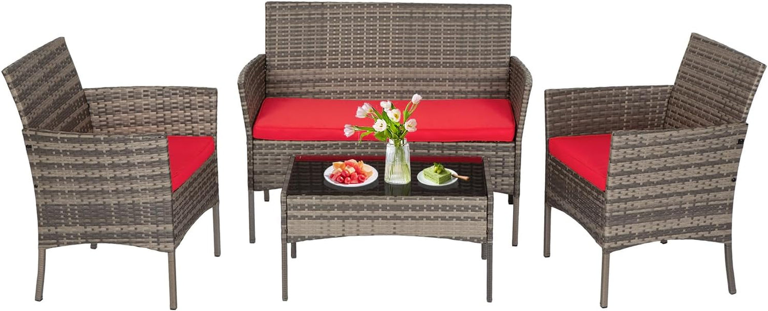 Four-piece light gray-brown woven rattan set with red seat cushions and glass-top coffee table, photographed on white
