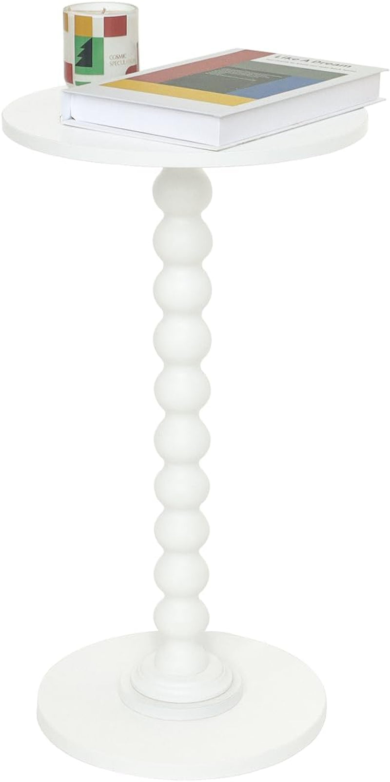 White round side table with stacked-ball central column, book and candle on top