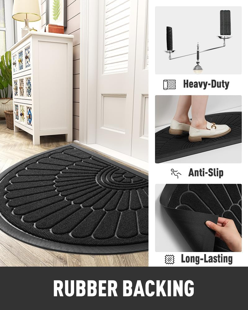Black semicircular doormat staged at an interior entry with inset panels showing anti-slip surface and rubber backing details