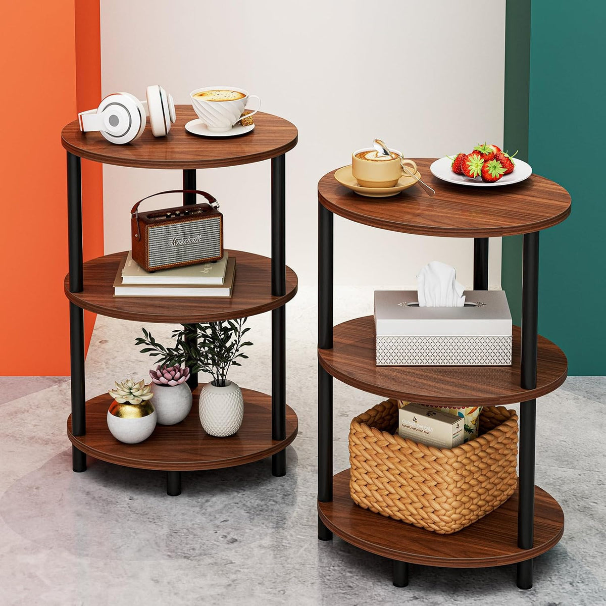 Two round three-tier wood-finish end tables side by side holding decor, a tissue box and a woven basket.