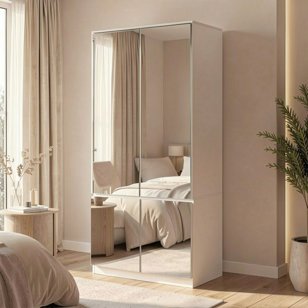 White mirrored wardrobe with four-panel mirrored doors, angled front view showing bed reflection in a bedroom setting