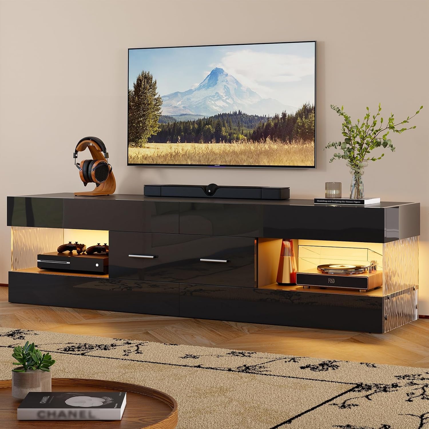 Black glossy TV stand angled view with warm amber LED lighting and textured side panels