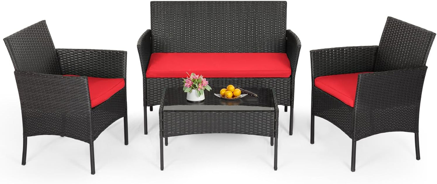 Black woven loveseat and two armchairs with bright red cushions and a rectangular glass-top coffee table.