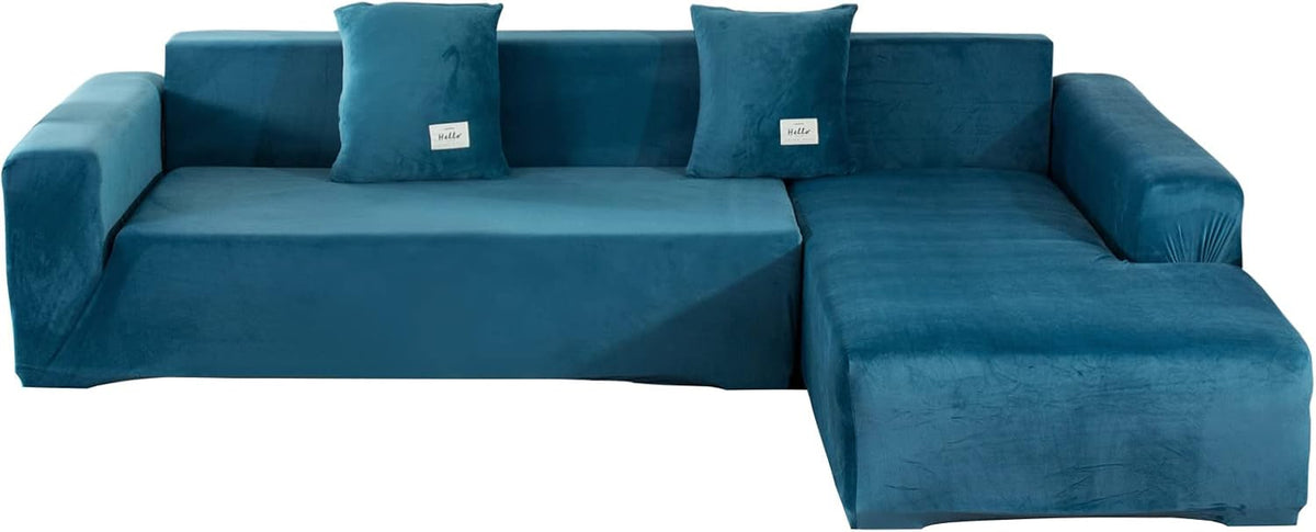 Teal velvet L-shaped slipcover front view with chaise on the right and two matching square pillows