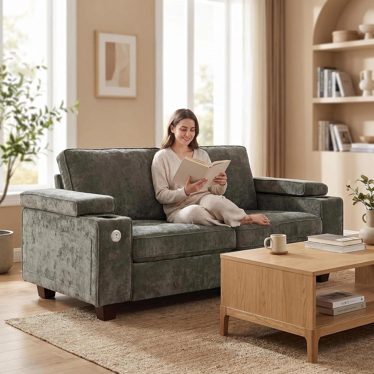 Two-seat textured green sofa in a sunlit living room with a woman reading, wood coffee table and rug