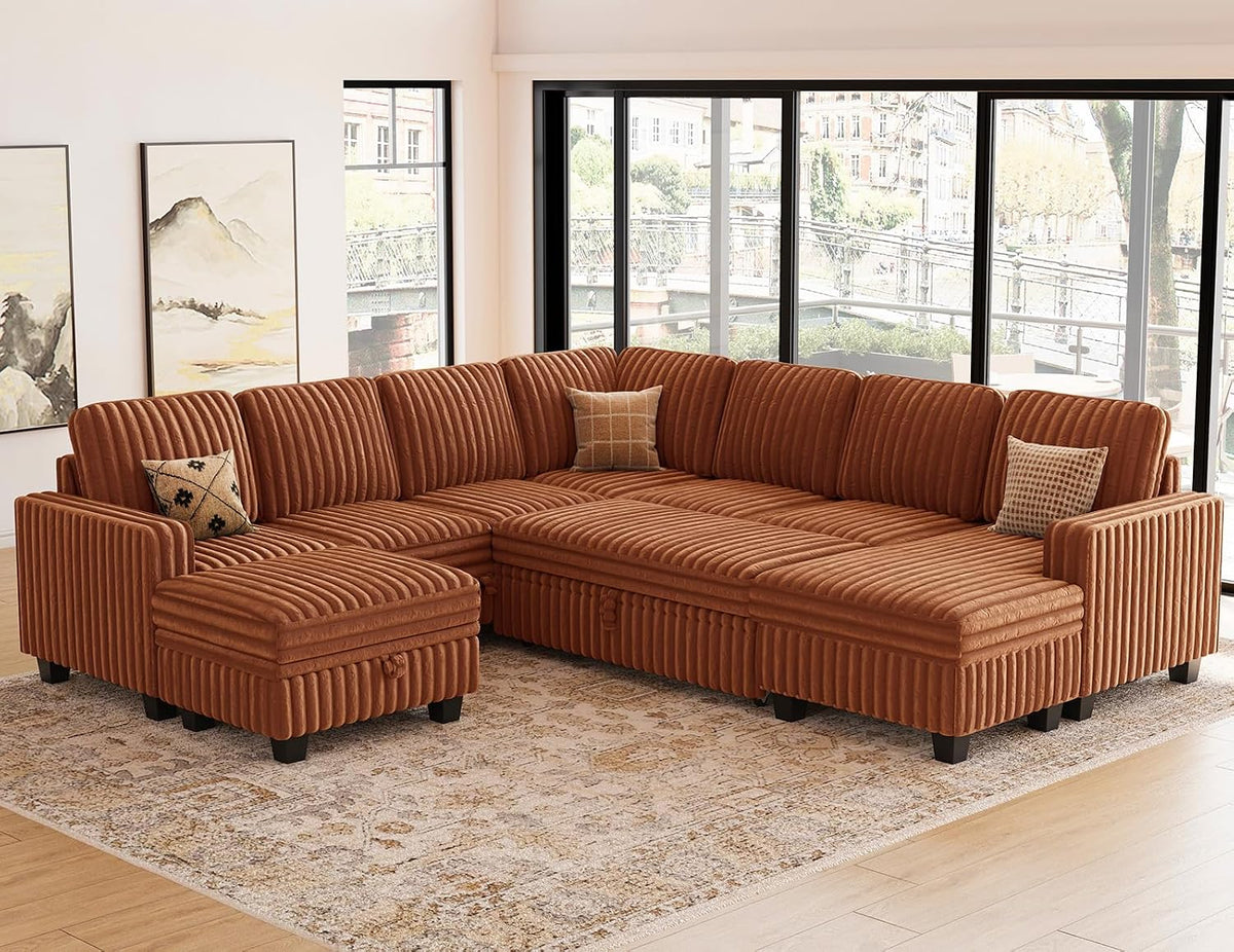 Wide shot of the rust corduroy sectional in an L-shape with a matching ottoman placed apart on a patterned rug