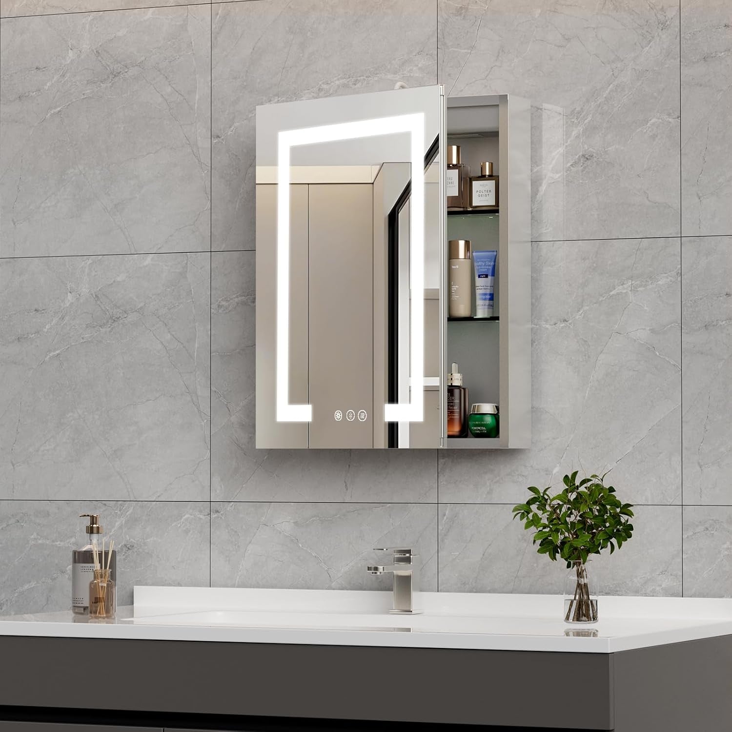 LED-lit mirrored cabinet on gray tile wall, door slightly open to reveal glass shelves stocked with toiletries and touch